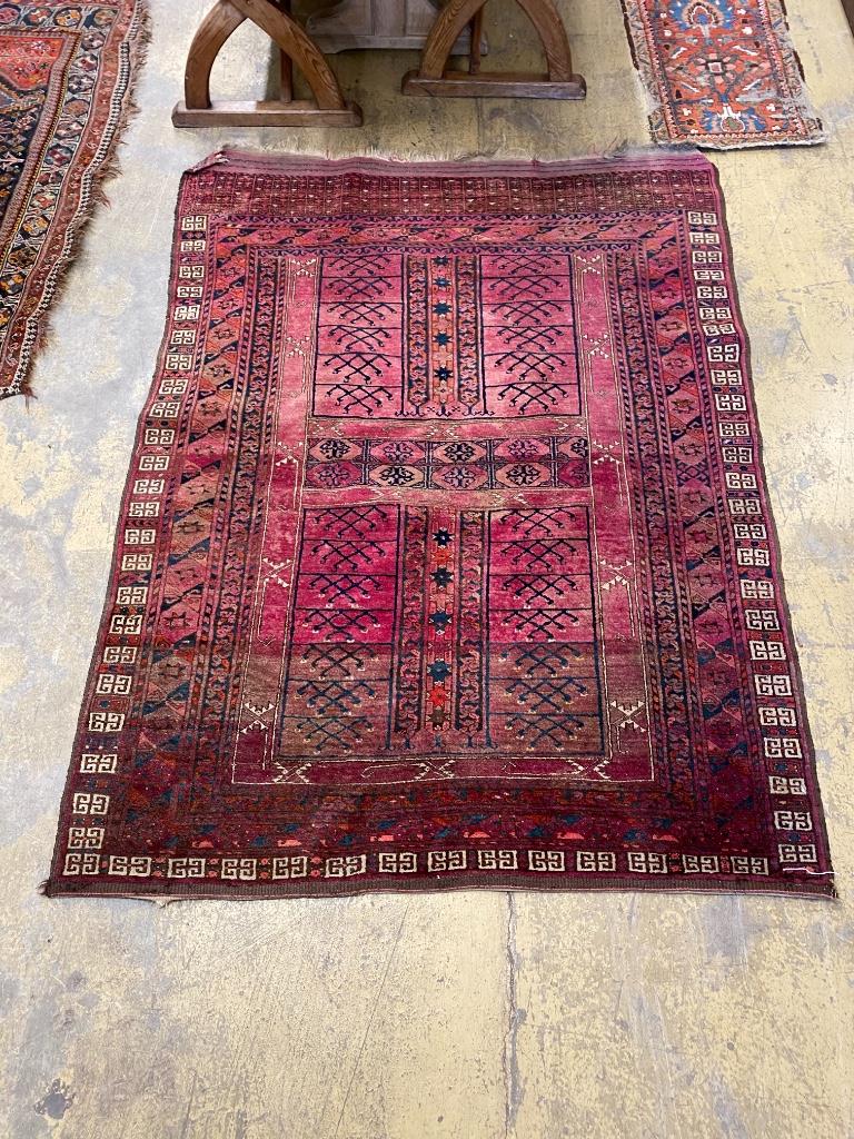 A Belouch burgundy ground rug, 190 x 150cm